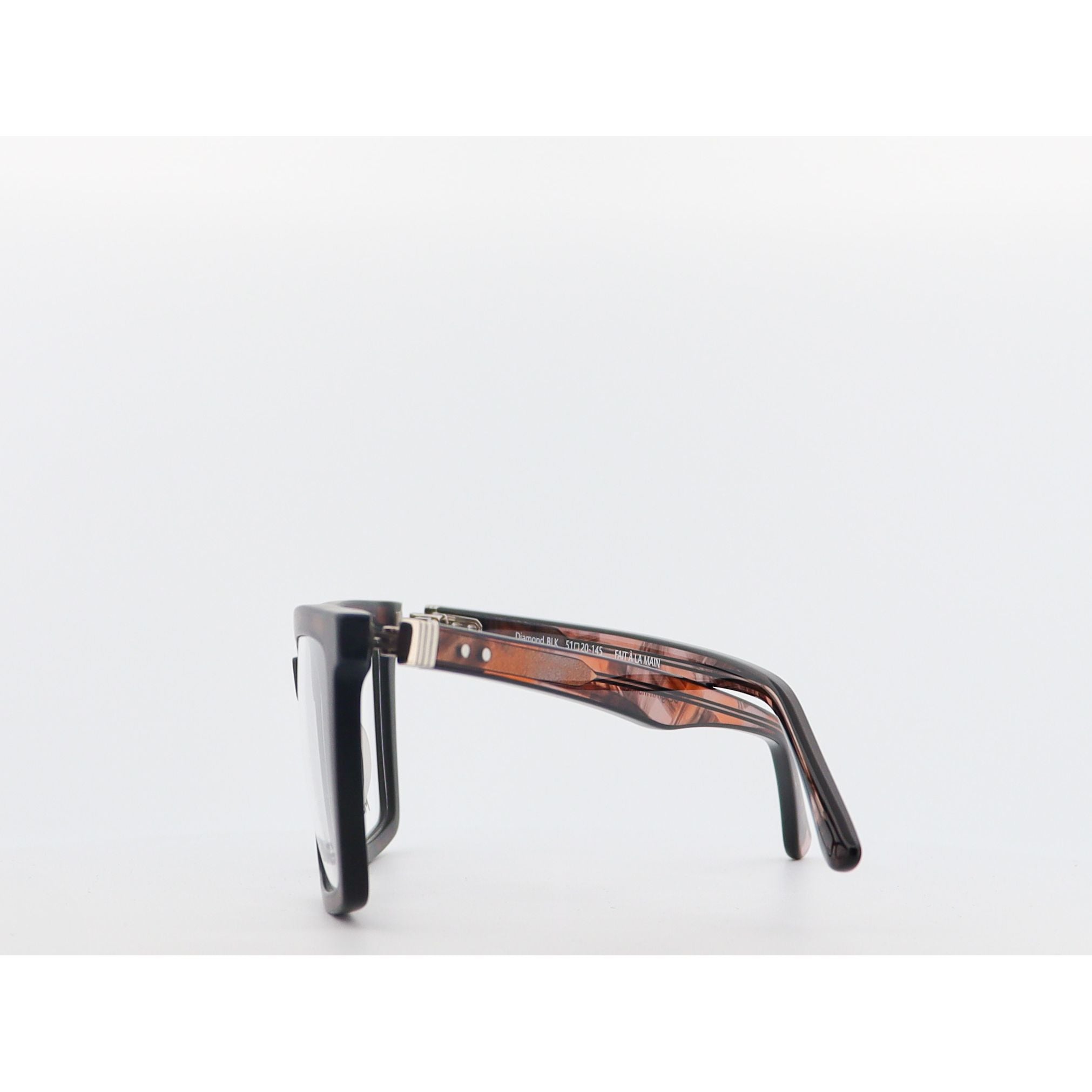 tortoiseshell frame and black lenses on a white background