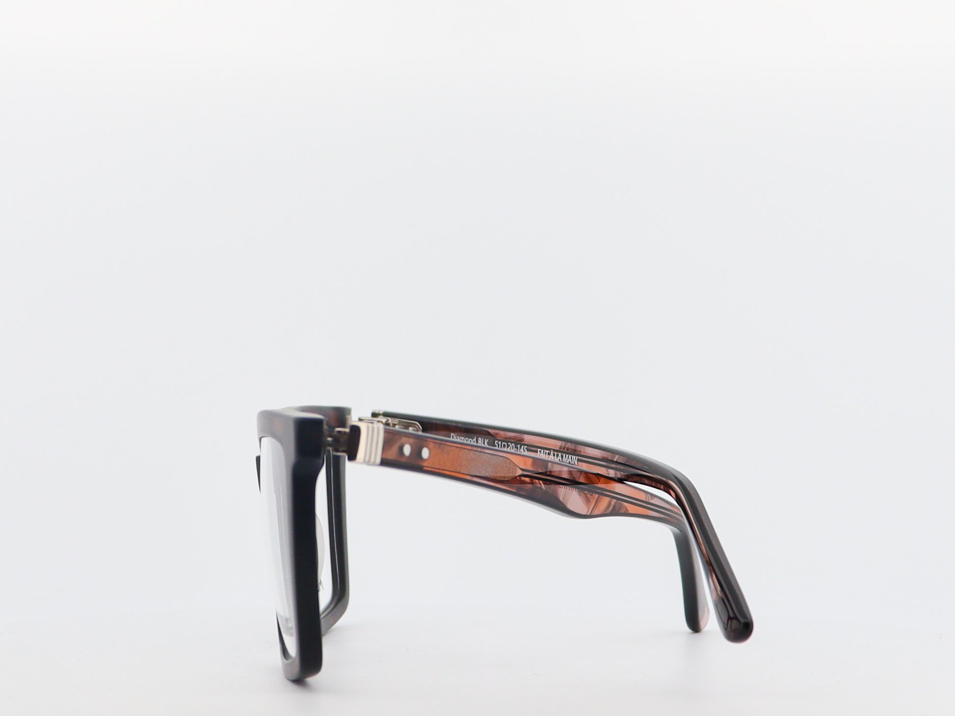 tortoiseshell frame and black lenses on a white background