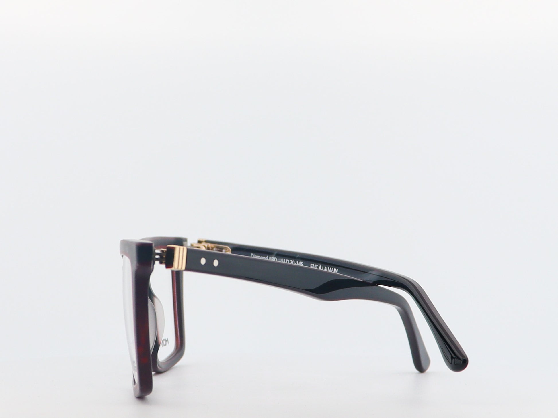 Black and gold eyeglasses on a white background