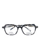 A pair of eyeglasses with a black and white patterned frame, front view.